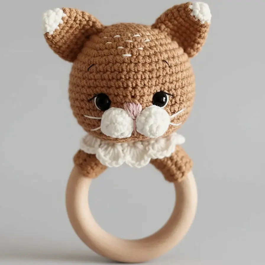 Crocheted cat baby rattle with wooden ring, soft brown and white colors