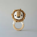 Crocheted lion baby teething ring with wooden circle and cute smiling face