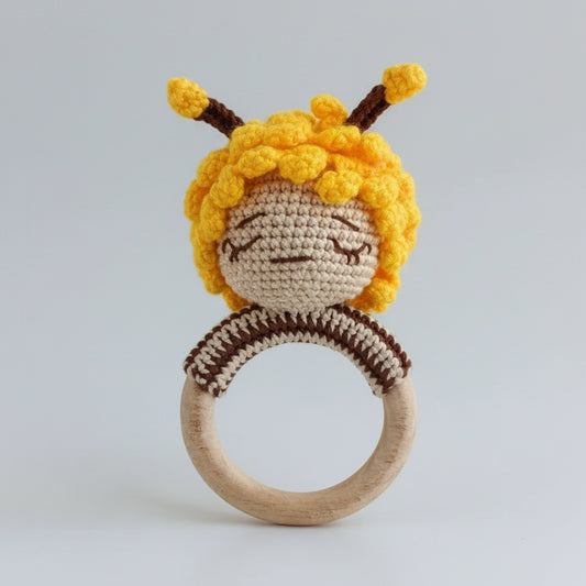 Crocheted bee baby rattle with wooden ring, yellow and brown yarn colors