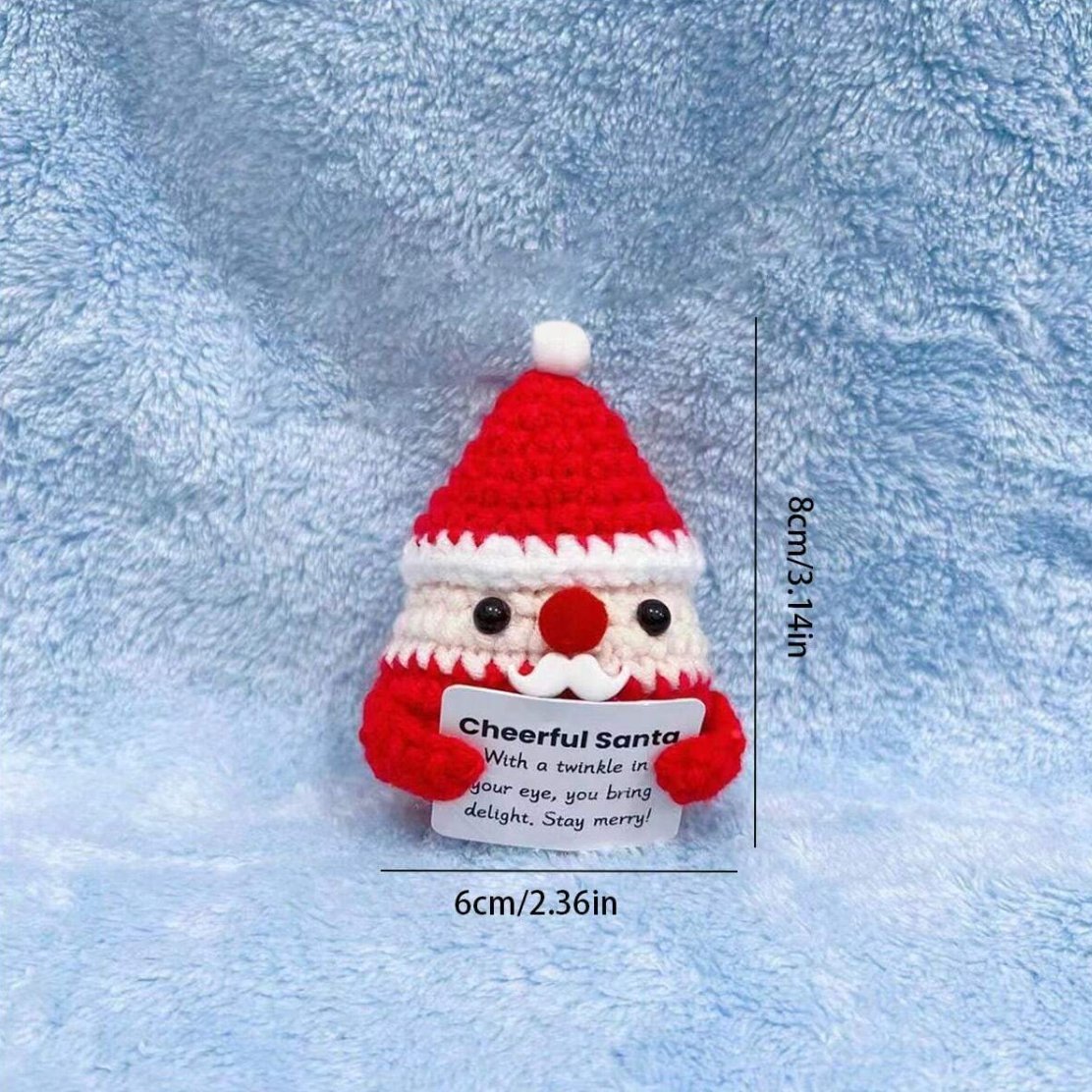 Crocheted Santa figurine with cheerful message on blue fuzzy background