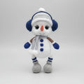 Crocheted snowman with blue earmuffs, scarf, and buttons, standing on a white background