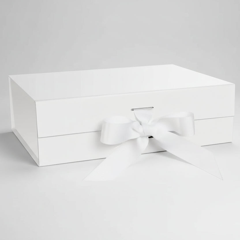 White gift box with elegant white ribbon bow, closed and pristine