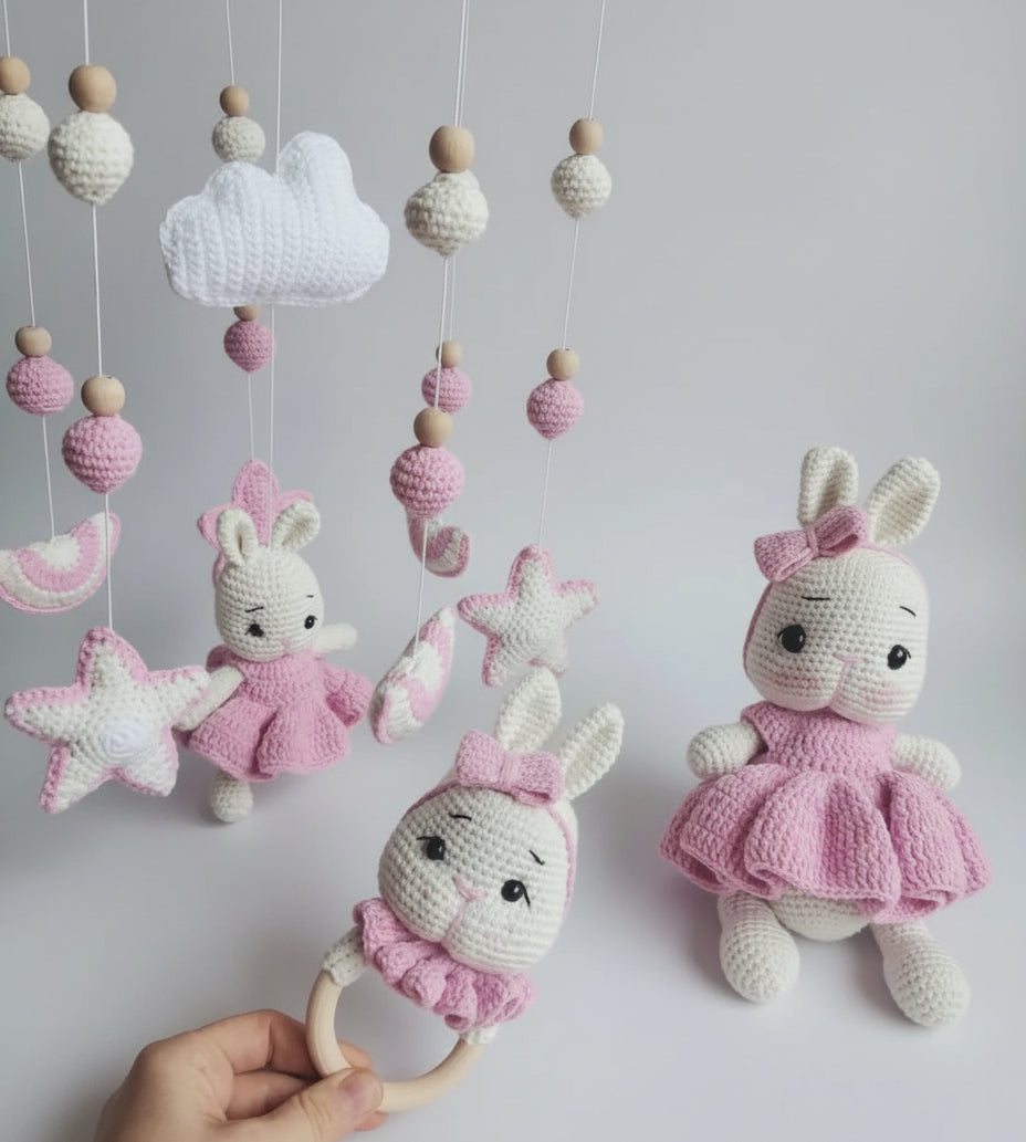 Crocheted pink and white bunny dolls with matching hanging mobile and teething ring