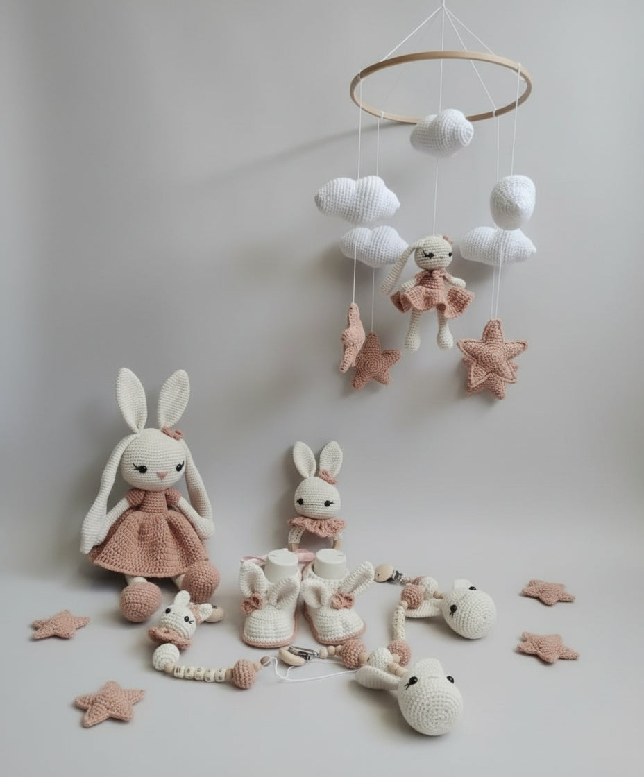 Crocheted baby mobile with bunny dolls, clouds, stars in soft pink and white colors