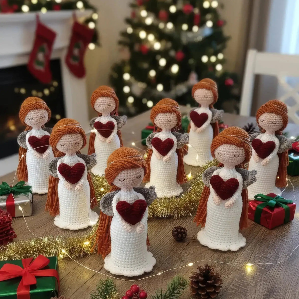 Crocheted angels with red hearts, surrounded by Christmas decorations and gifts
