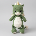 Handmade green dragon plush toy held by a person on a light surface.
