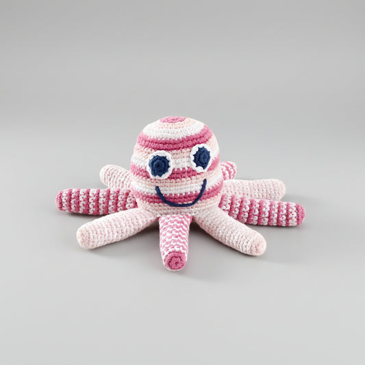 Crocheted pink and white octopus toy with a smiling face and blue eyes