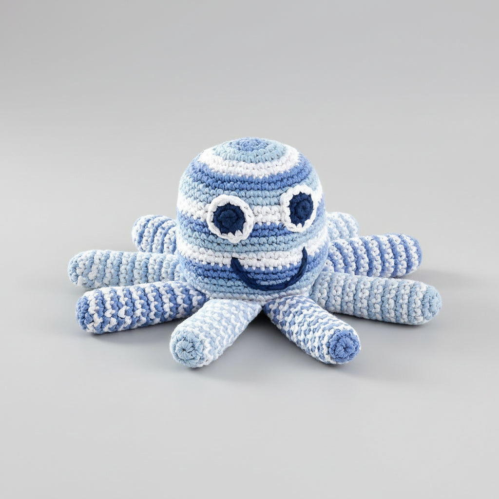 Blue and white crocheted octopus toy with smiling face and round eyes