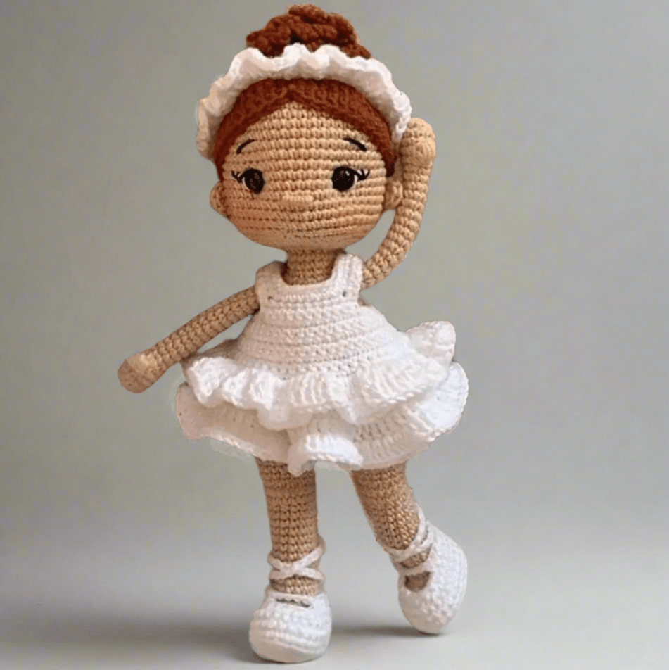 Crocheted ballerina doll in white tutu with ruffled trim and ballet shoes