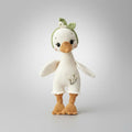 Crocheted white duck with green leaf hat and orange beak and feet
