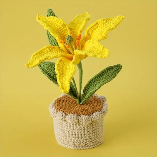 Crocheted yellow lily flower with green leaves in a textured beige pot