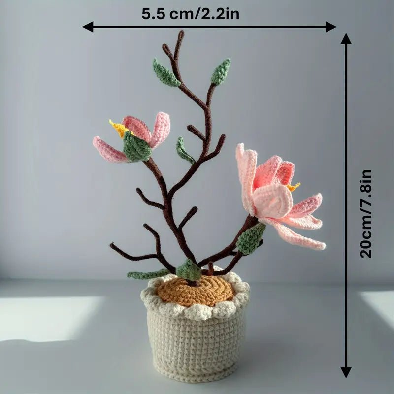 Crocheted pink flower tree with brown branches in a white textured pot
