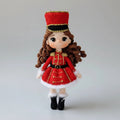 Crocheted doll in red military-style uniform with curly hair and gold trim