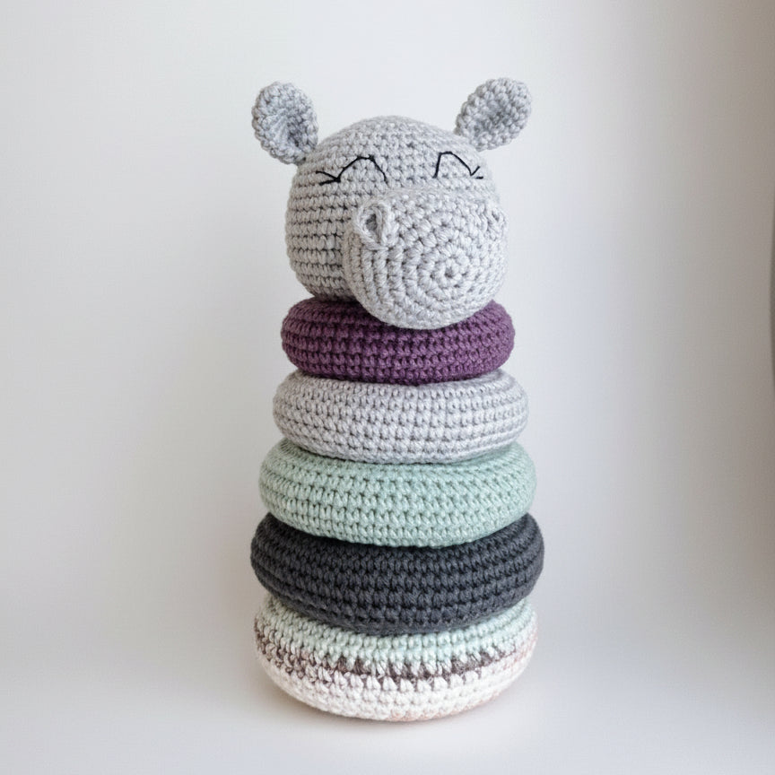 Crocheted stacking toy with cute animal face, rings in soft purple, gray, and mint colors