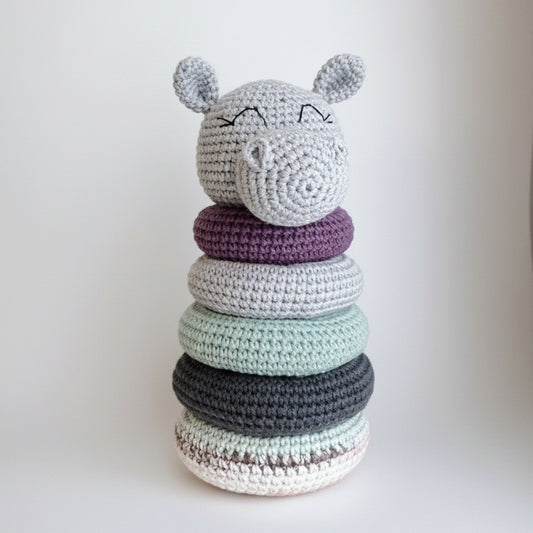 Crocheted stacking toy with cute animal face, rings in soft purple, gray, and mint colors