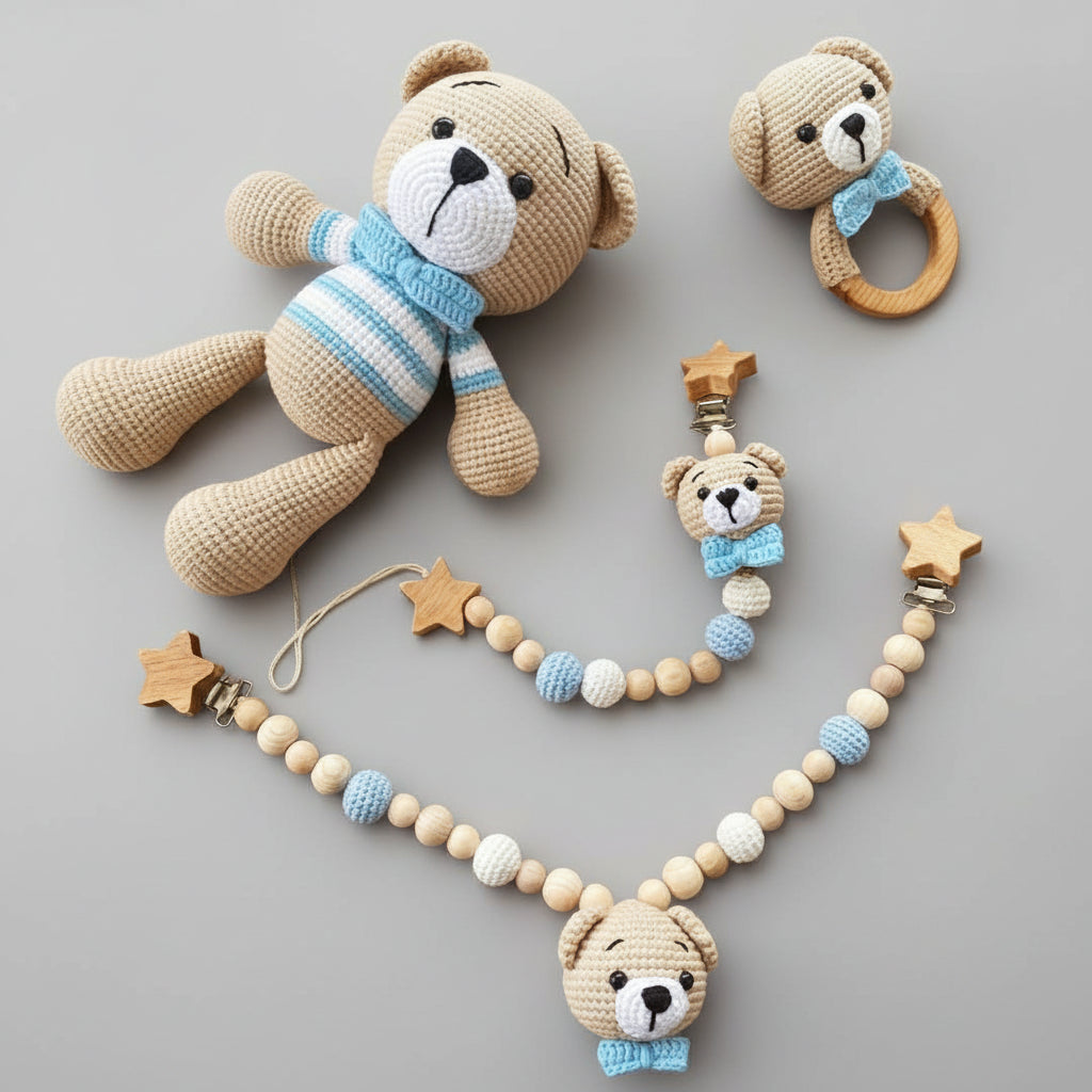 Crocheted teddy bear, rattle, and pram chain in blue and beige with wooden star clips