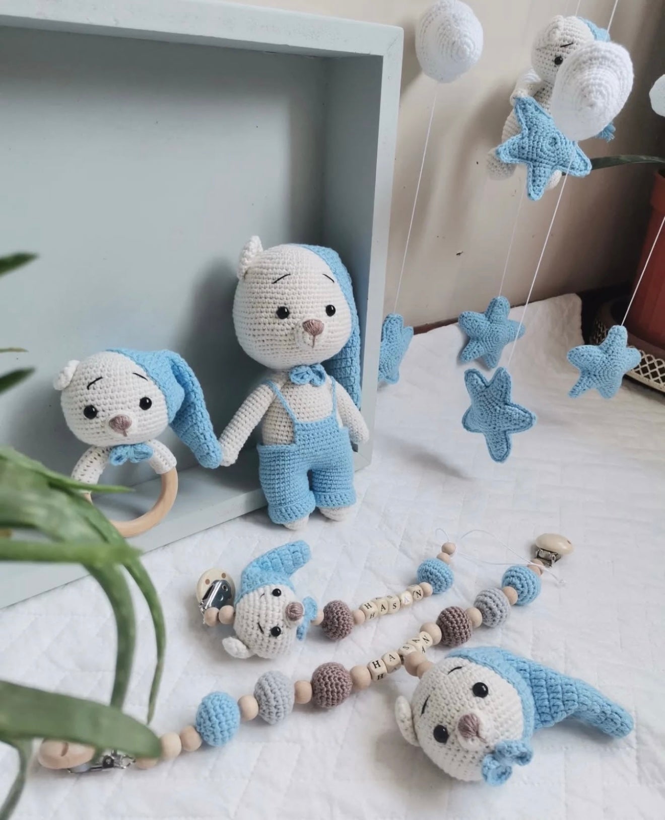 Handmade blue and white crochet baby toys: bunnies, stars, and pacifier clips