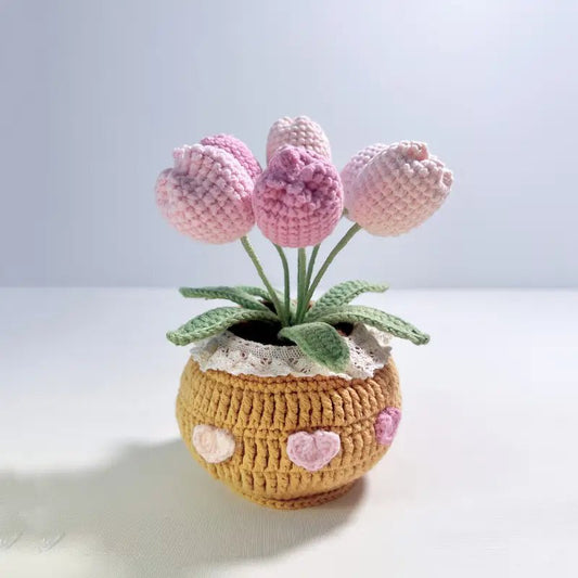 Crocheted pink tulips in a yellow pot with heart decorations and lace trim