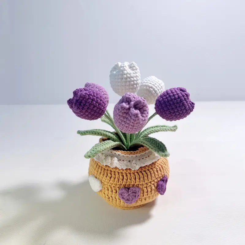 Crocheted tulips in yellow and purple, nestled in a textured pot with lace trim