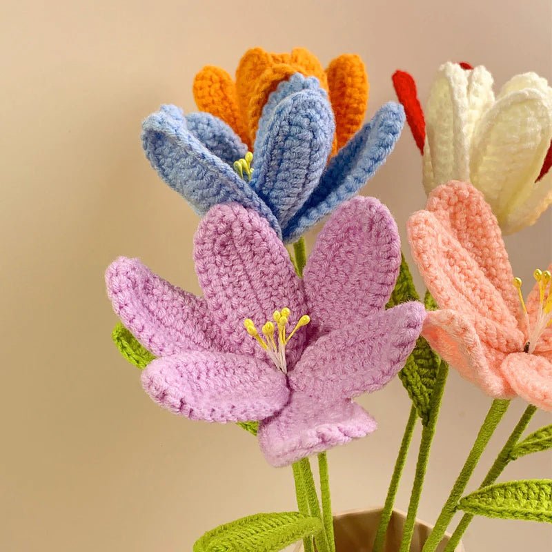 Colorful crocheted flowers in pastel shades with textured yarn petals and stems