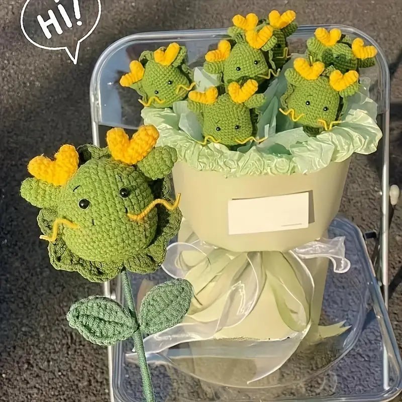 Crocheted green dinosaur flowers with yellow hearts in a pastel gift box