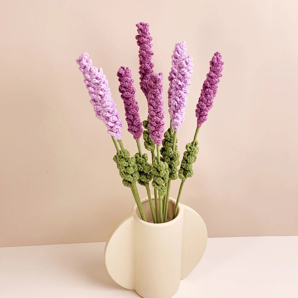 Crocheted lavender stems in purple and green, arranged in a white modern vase.