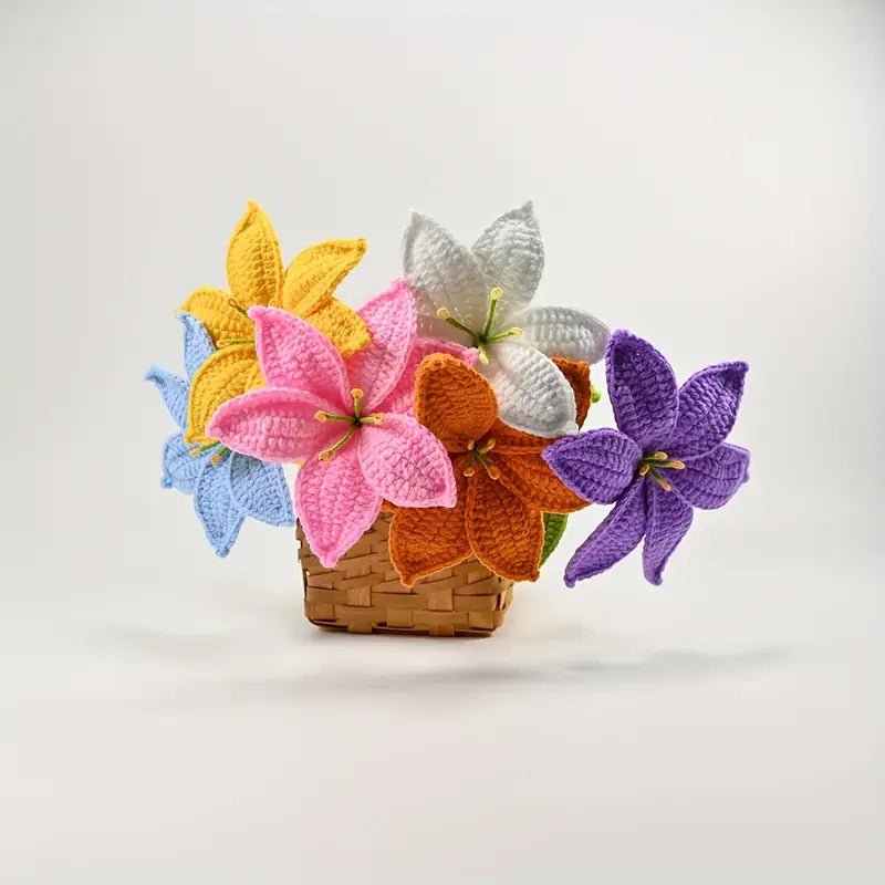 Colorful crocheted lily flowers in a woven basket against a white background
