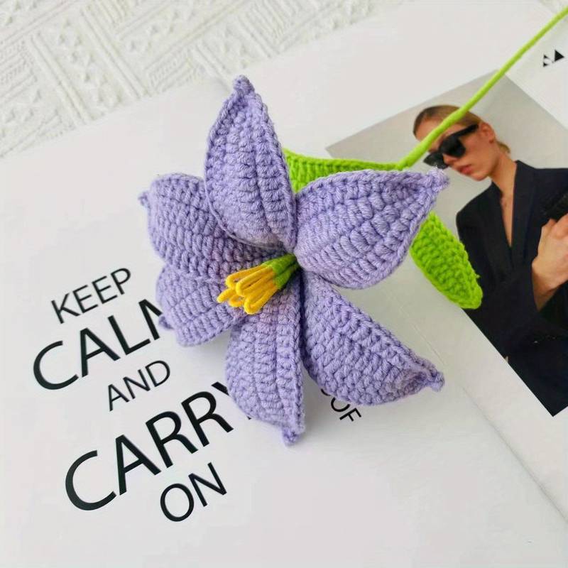 Purple crocheted flower with yellow center on "Keep Calm and Carry On" poster background