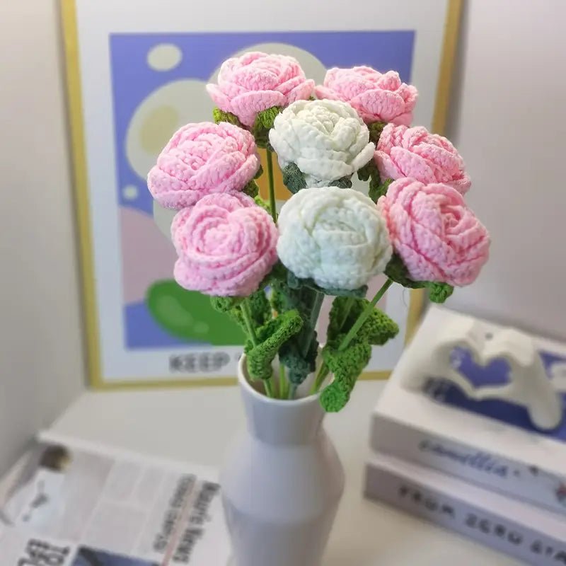 Crocheted pink and white roses in a vase, with green stems and leaves