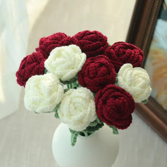 Crocheted red and white roses in a white ceramic vase, handmade yarn flowers