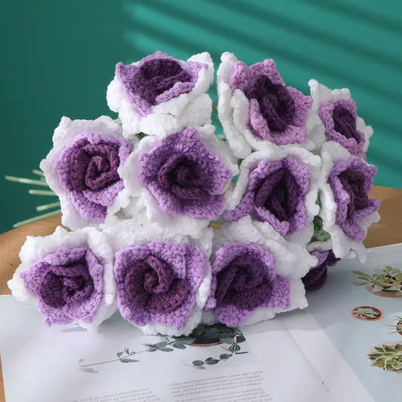 Handmade crocheted roses in white and purple, soft and textured, arranged in a bouquet