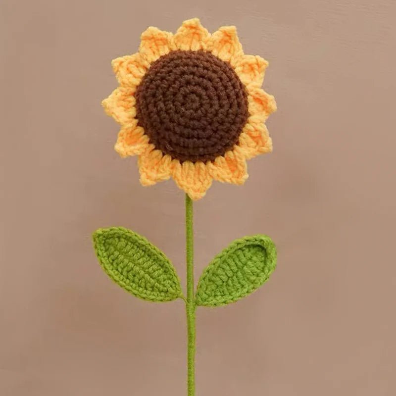Crocheted sunflower with brown center and yellow petals on green stem