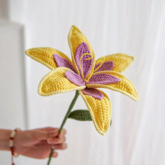 Crocheted yellow and purple lily with detailed textured petals and green stem