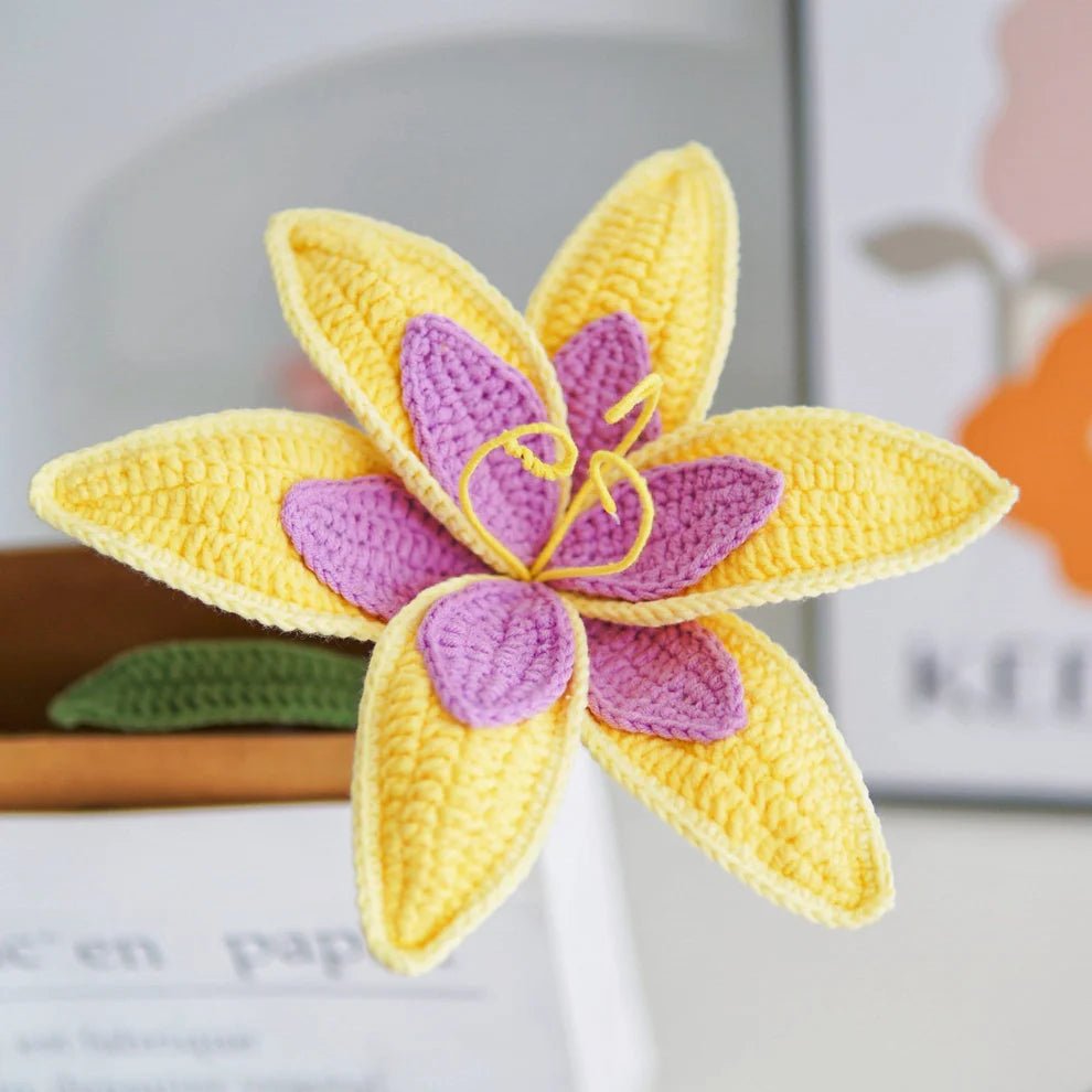 Crocheted yellow and purple flower with detailed textured petals and stamen
