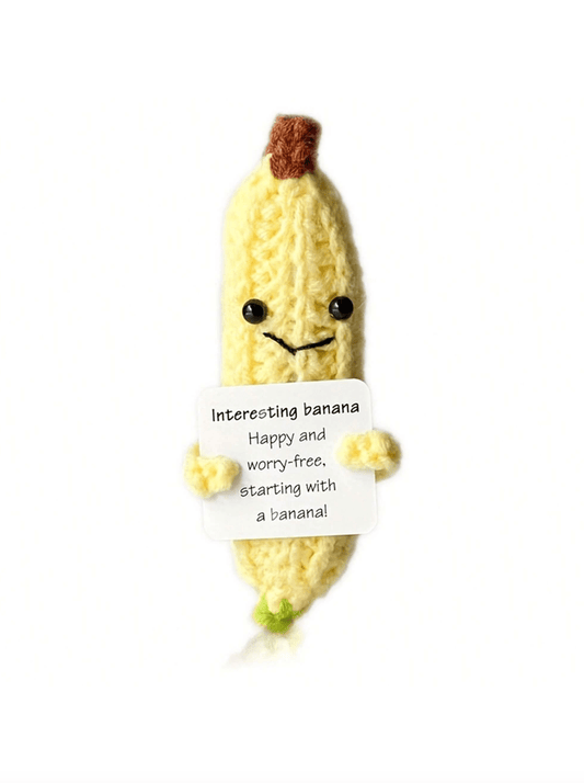 Cute knitted banana character holding a motivational message with a cheerful smile
