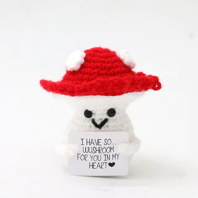 Cute crocheted mushroom holding a pun-filled love note with a red hat