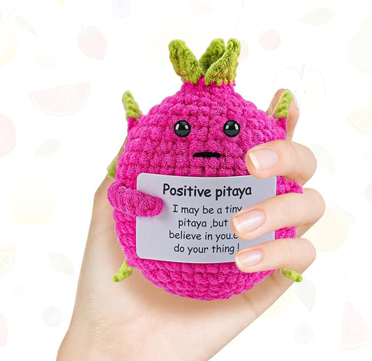 Cute pink crocheted pitaya plush with positive motivational message in hand