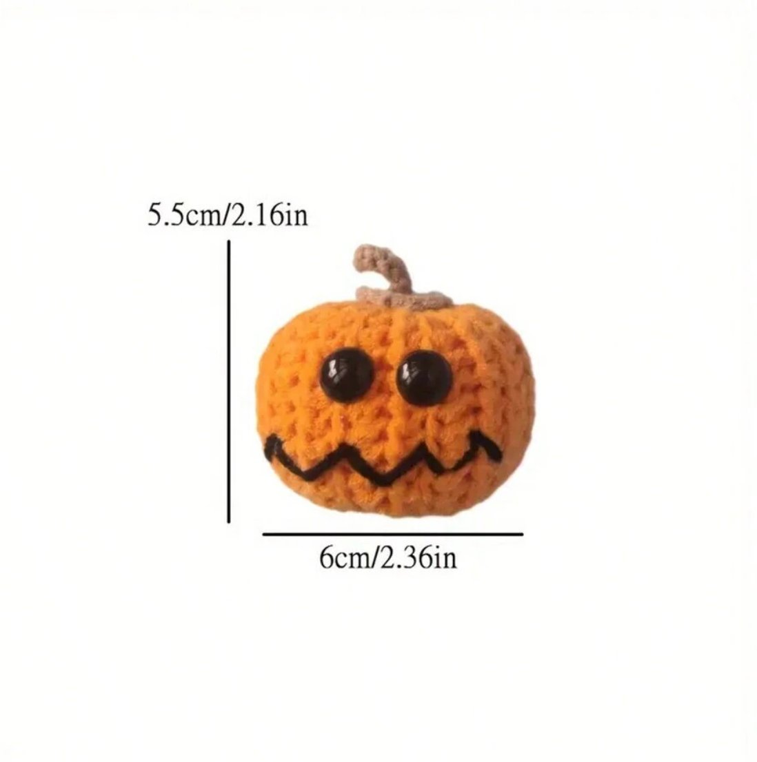 Knitted orange pumpkin with black button eyes and jagged smile, 5.5cm tall