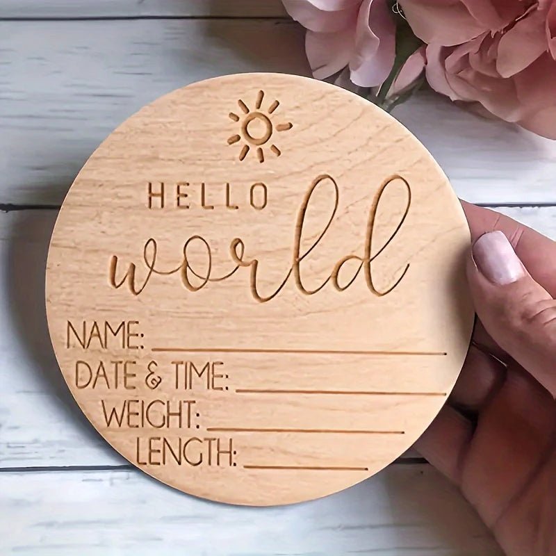 Wooden birth announcement sign with "Hello world" and space for baby details, sun icon