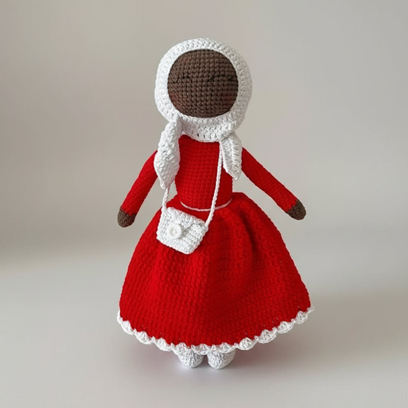 Crocheted doll in red dress with white bonnet and matching purse