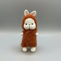 Crocheted bunny with fluffy orange-brown fur and white body, standing upright