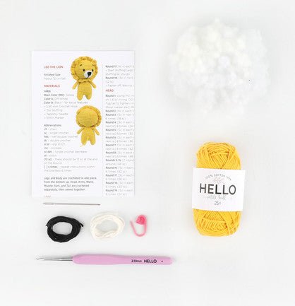 Crochet supplies for making a cute yellow amigurumi lion, with pattern and yarn