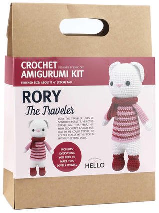 Craft kit packaging with crochet amigurumi doll in pink striped outfit