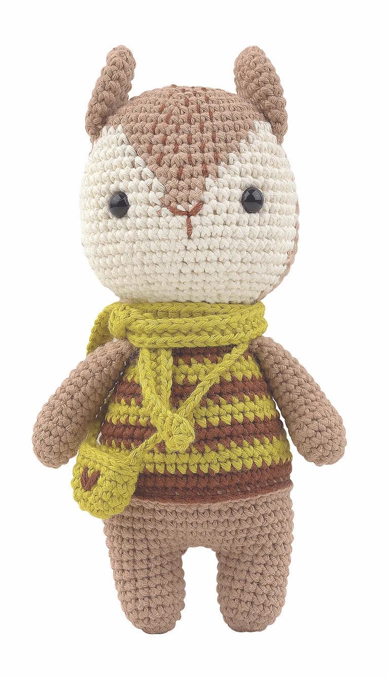 Crocheted stuffed animal bunny wearing striped sweater and yellow scarf