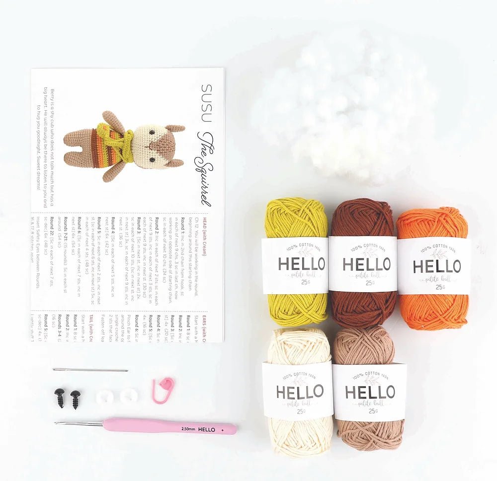 Crochet supplies with yarn, needles, and a half-finished crocheted bunny toy