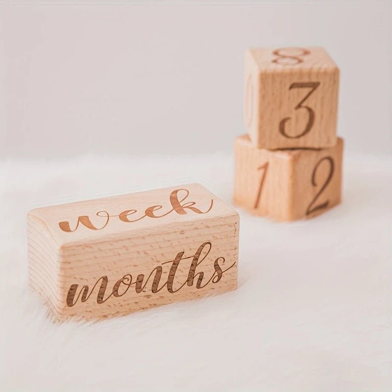 Wooden milestone blocks with "week" and "months" for tracking baby's growth stages