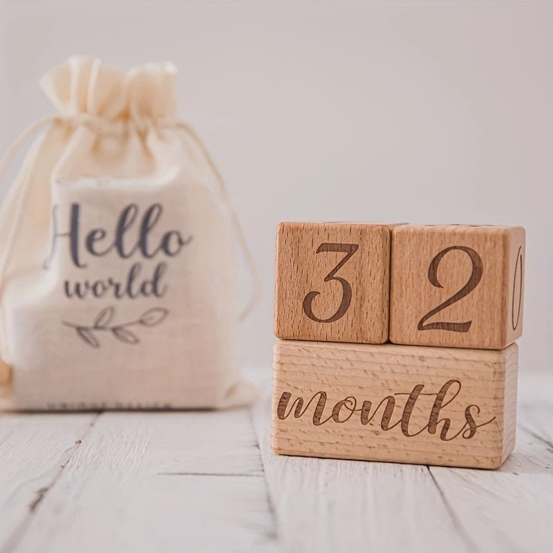 Wooden milestone blocks showing 32 months with "Hello world" drawstring bag