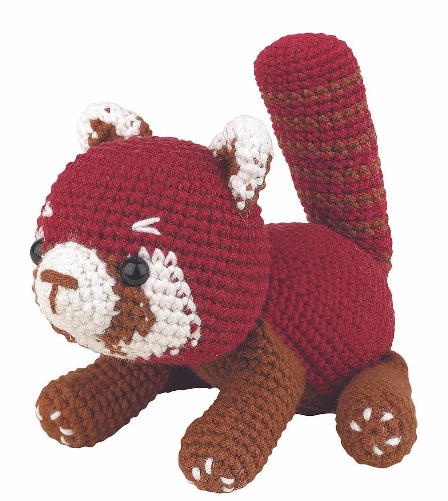 Crocheted red and brown squirrel with white accents, sitting cute and plump